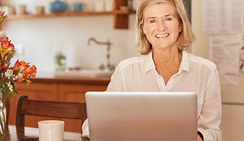 Smiling Senior Woman with a Laptop